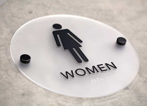 Round restroom signs with black stand offs